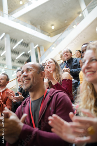 Enthusiastic audience clapping and cheering