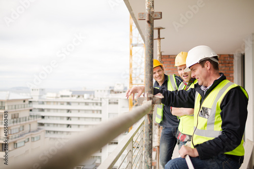 Construction workers talking at highrise construction site