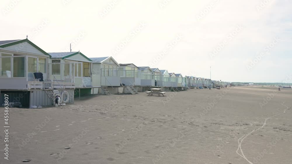 Panning shot of stretch of beach houses in Netherlands Panning shot of stretch of beach houses in Netherlands