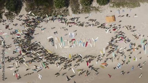 4k Top view drone shot of the protest on the beach shore against norwegian oil company at Byron Bay, New South Wales, Australia - 2019 photo