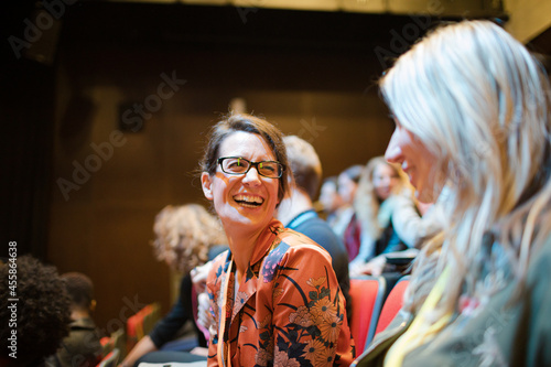 Businesswomen talking in conference audience
