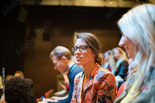 Businesswomen talking in conference audience