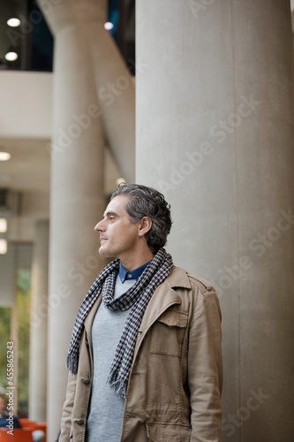 Man smiling outside building