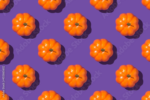 Top view closeup photo of orange pumpkins on isolated violet background