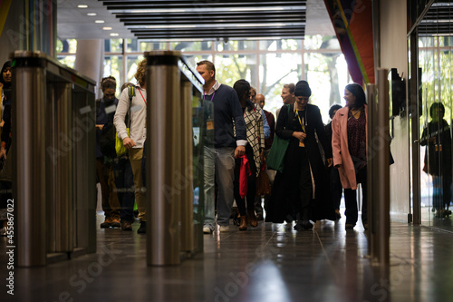 People entering auditorium hallway