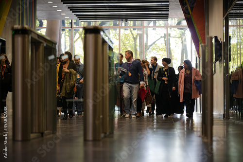 People entering auditorium hallway