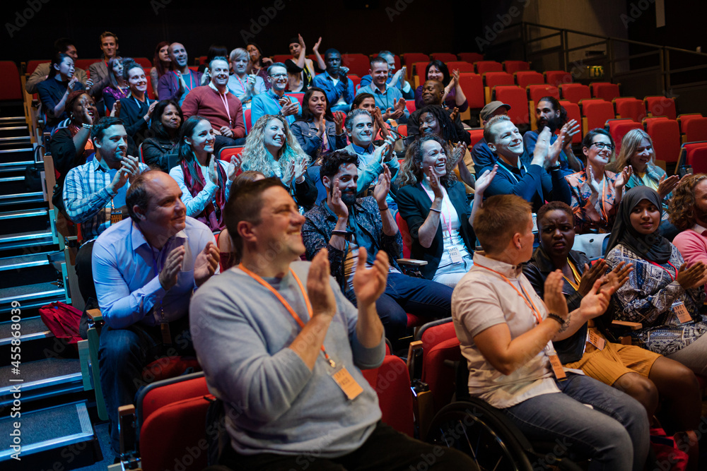 Audience clapping in dark room Audience clapping in dark room