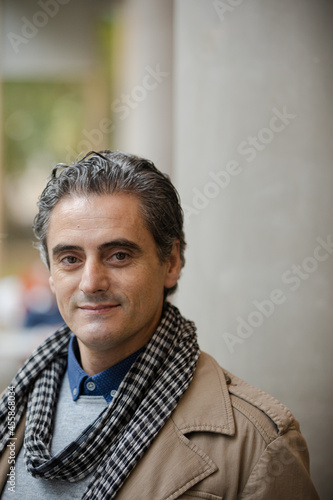 Man smiling outside building