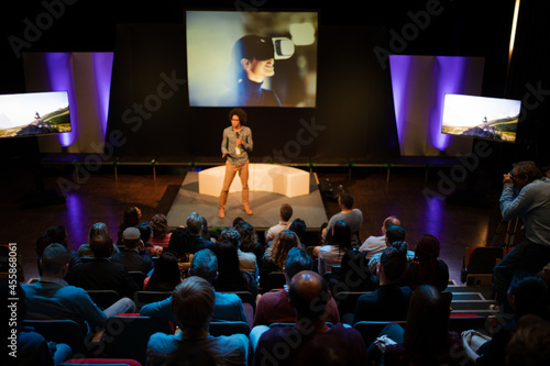 Audience watching male speaker on stage