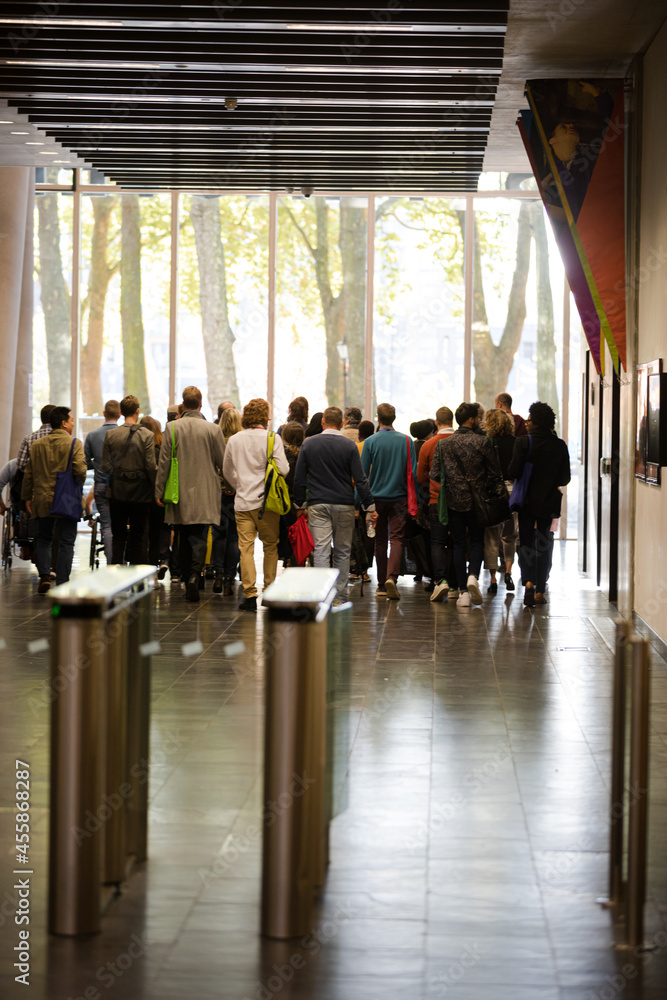 People leaving auditorium hallway