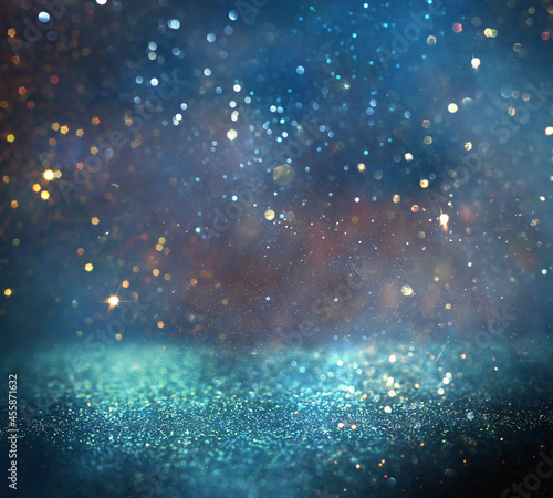 background of abstract glitter lights. gold  blue and black. de focused. banner