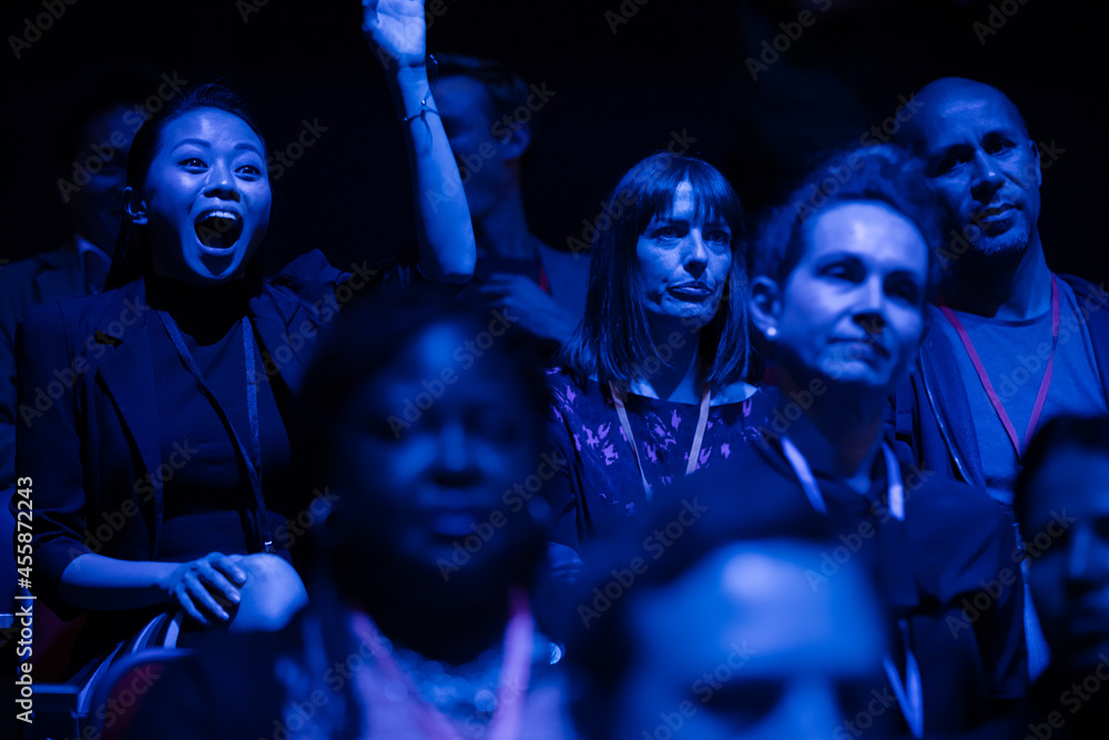 Smiling, enthusiastic audience in dark auditorium Smiling, enthusiastic audience in dark auditorium