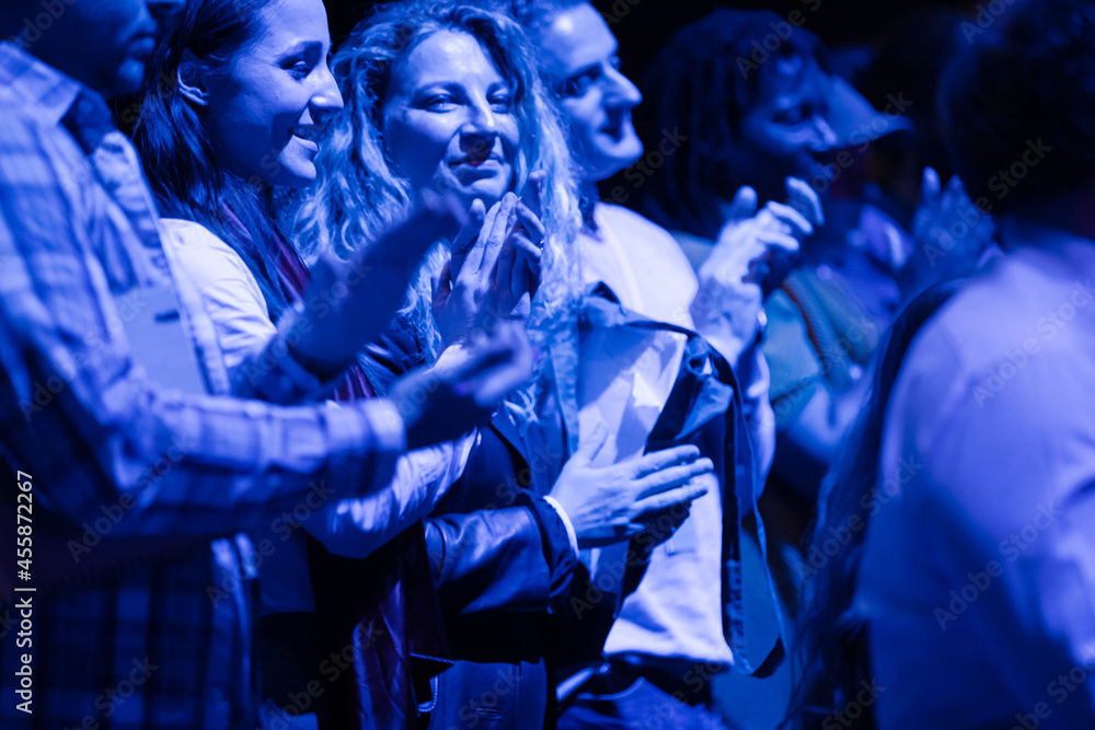 Audience clapping in dark room Audience clapping in dark room