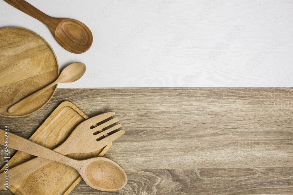 wooden kitchen utensils on wooden and white background wooden kitchen utensils on wooden and white background