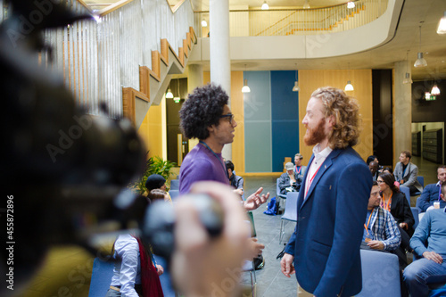 Businessmen talking during conference break