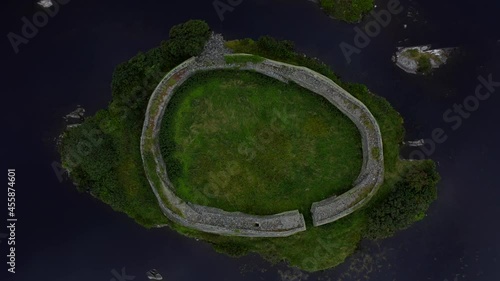 Ringfort, Doon Lough, Portnoo, County Donegal, Ireland, September 2021. Drone birds-eye view, slowly ascending while rotating counter-clockwise above the island-fort. photo
