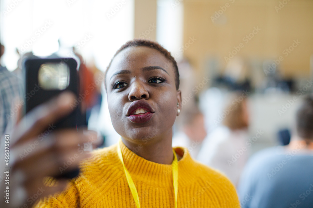 Fototapeta premium Smiling woman using smart phone