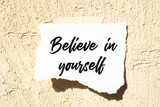 Motivational quote. Believe in yourself written on white card with paper clip.