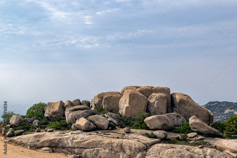 On the mountains along the coast, there are few plants and many large stones of various shapes On the mountains along the coast, there are few plants and many large stones of various shapes