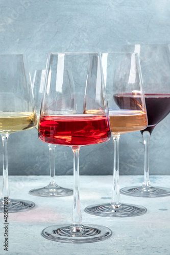 Rose, red and white wine in elegant modern glasses at a wine tasting at a winery. Winetasting event