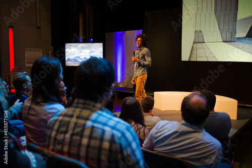 Male speaker with microphone talking to audience