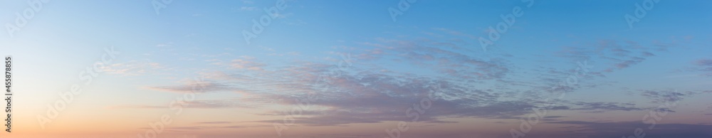 Blue sky with clouds at sunset, large panoramic shot.