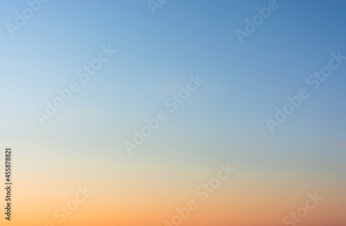 Sky background. A blue sky landscape illuminated by the light of an evening sunset - a view of the evening sky.