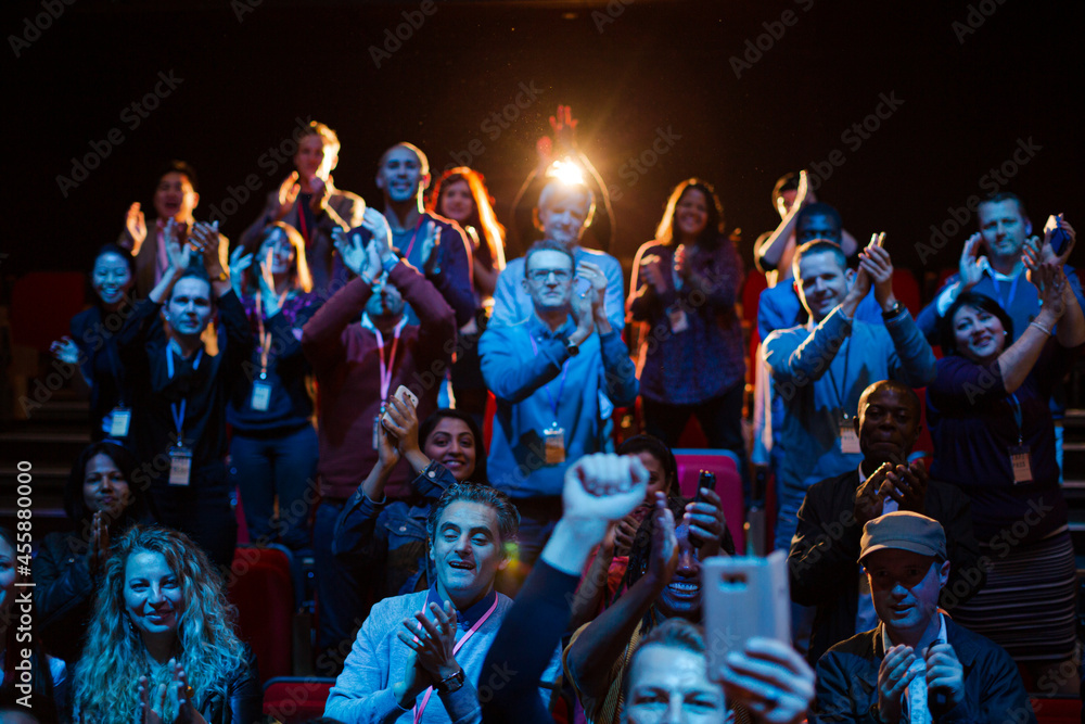 Smiling, excited audience cheering