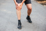 A man having knee when running or jogging