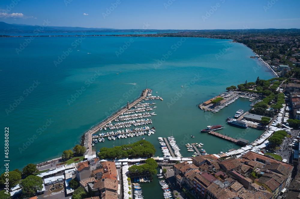Aerial panorama of the town of Desenzano del Garda on Lake Garda in Italy. Italian resorts on Lake Garda. Top view of the boat parking on the lake. Aerial view of Desenzano del Garda.