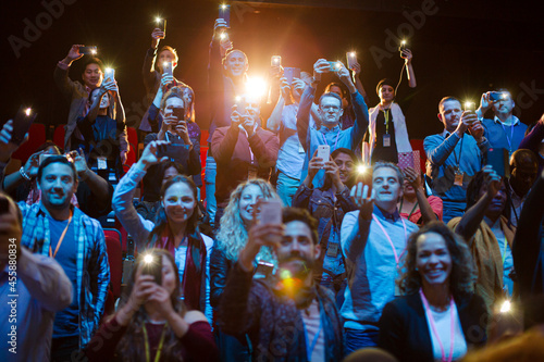 Smiling, excited audience cheering