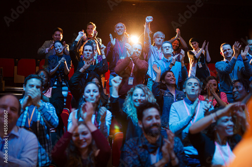 Smiling, excited audience cheering