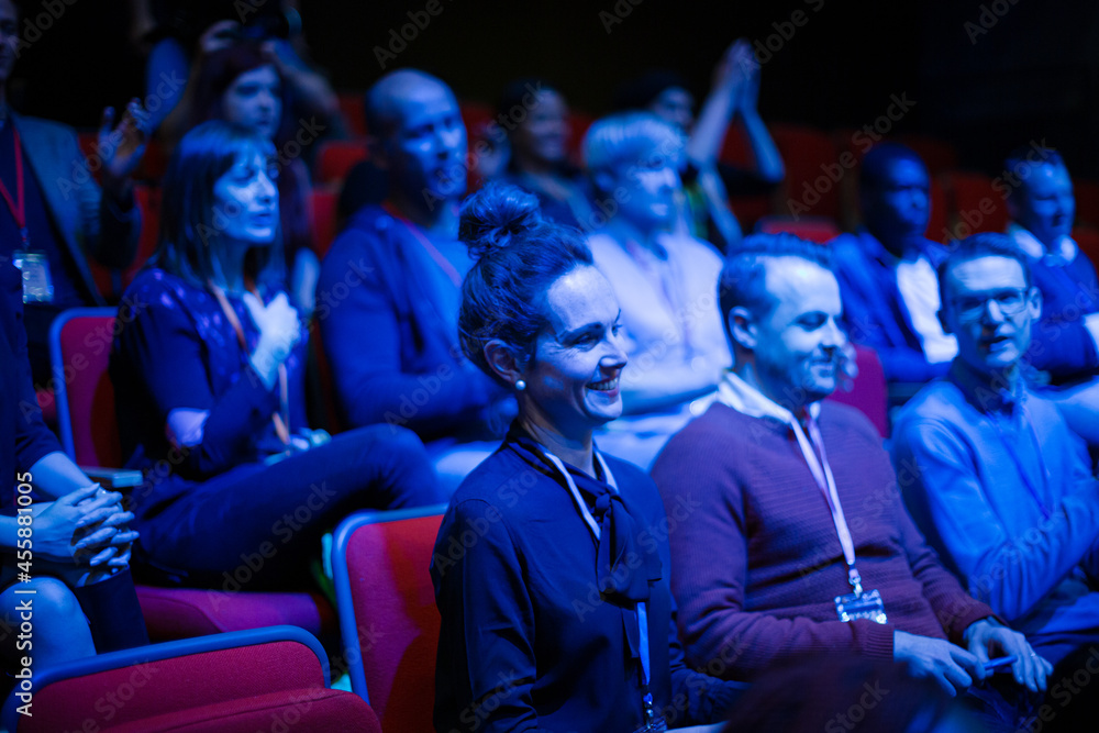 Audience clapping in dark room Audience clapping in dark room