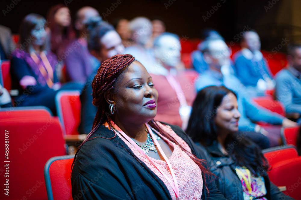 Attentive woman listening in conference audience