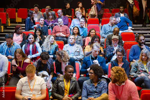 Audience arriving and sitting in auditorium