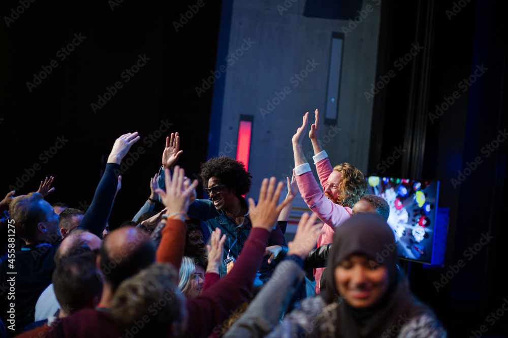 Fototapeta premium Audience reaching for and talking with speakers
