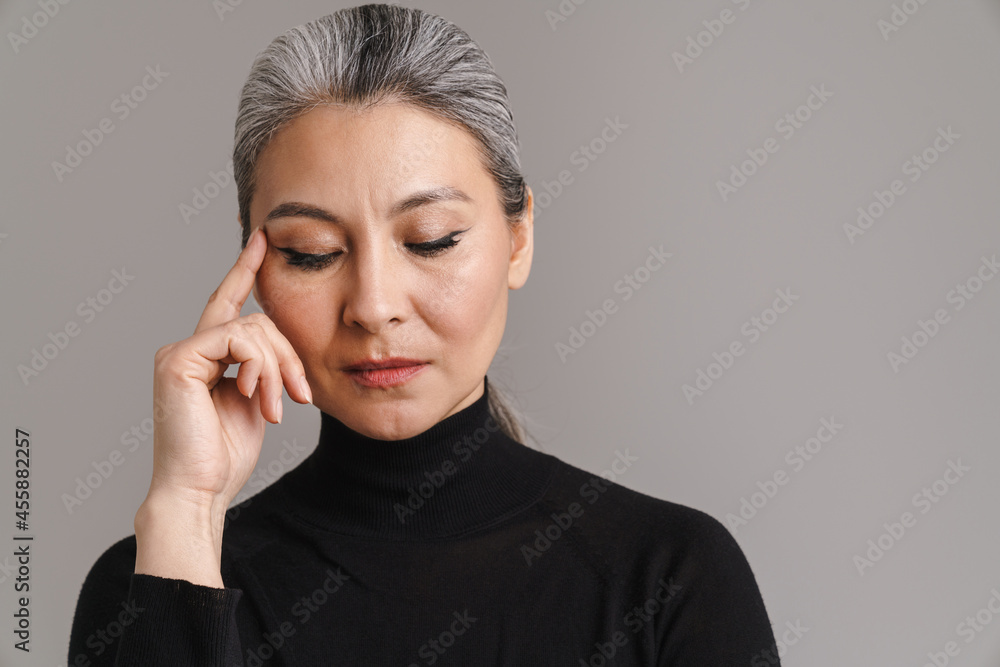 Mature asian white woman posing with her eyes closed Mature asian white woman posing with her eyes closed