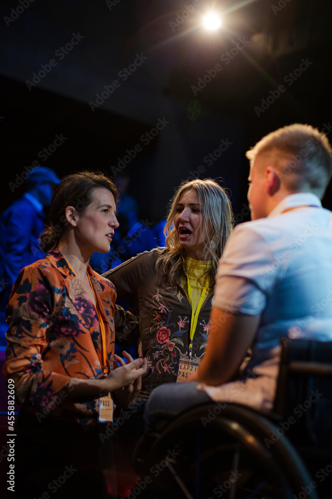 Audience talking to speaker in wheelchairs on stage