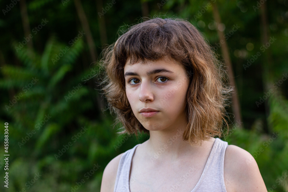 Serious teenager girl looking angry. Curly pretty young girl outside Serious teenager girl looking angry. Curly pretty young girl outside