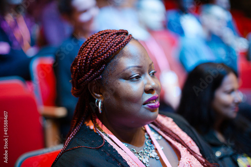 Attentive woman listening in conference audience