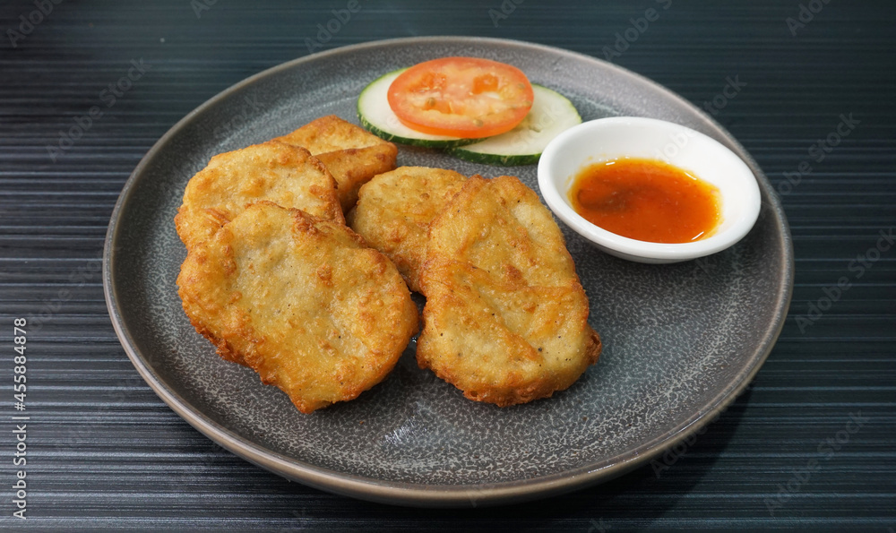 deep fried golden chicken nugget fritter with sauce on dark grey wood background dim sum halal menu deep fried golden chicken nugget fritter with sauce on dark grey wood background dim sum halal menu