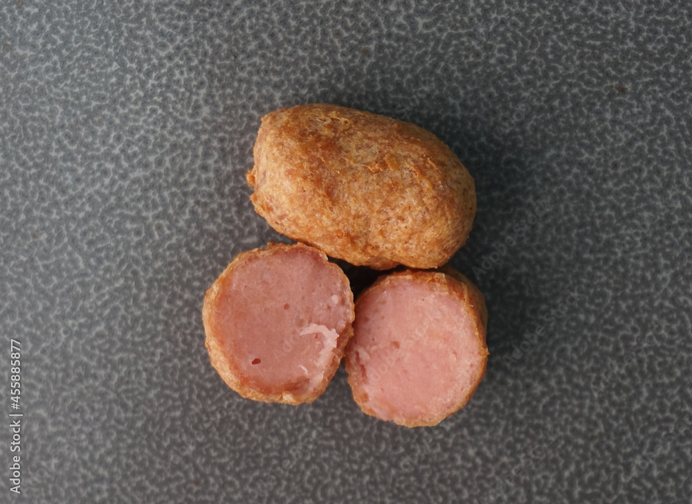 deep fried mini hot dog sausage luncheon meat with spicy sauce on dark grey wood background dim sum halal menu deep fried mini hot dog sausage luncheon meat with spicy sauce on dark grey wood background dim sum halal menu