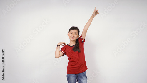 beautiful little girl pointing up blank space isolated on white background