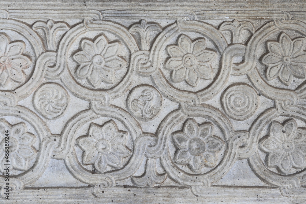 Ancient Carved Stone Fragment with Flowers at Santa Maria in Trastevere Basilica in Rome, Italy