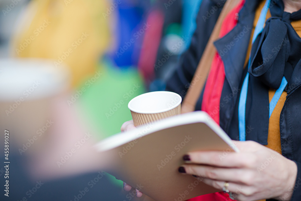 People holding coffee cups during conference break