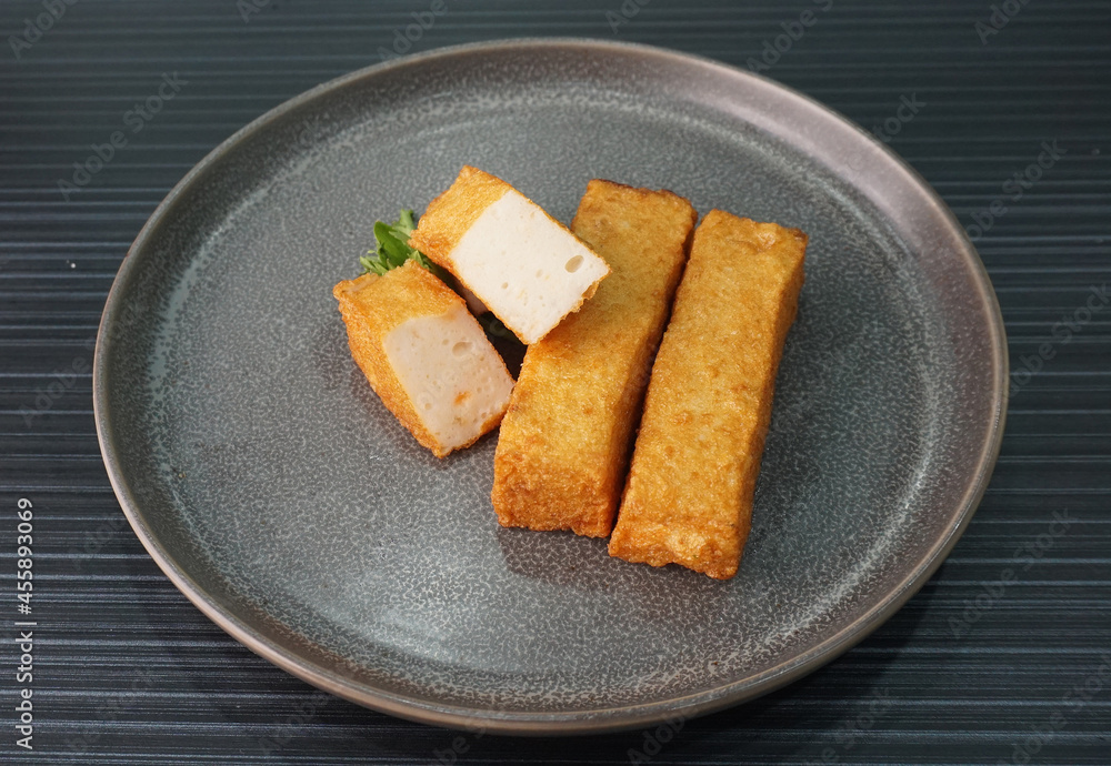 deep fried long golden stick salmon fish seafood paste cake on dark grey wood background dim sum halal menu deep fried long golden stick salmon fish seafood paste cake on dark grey wood background dim sum halal menu