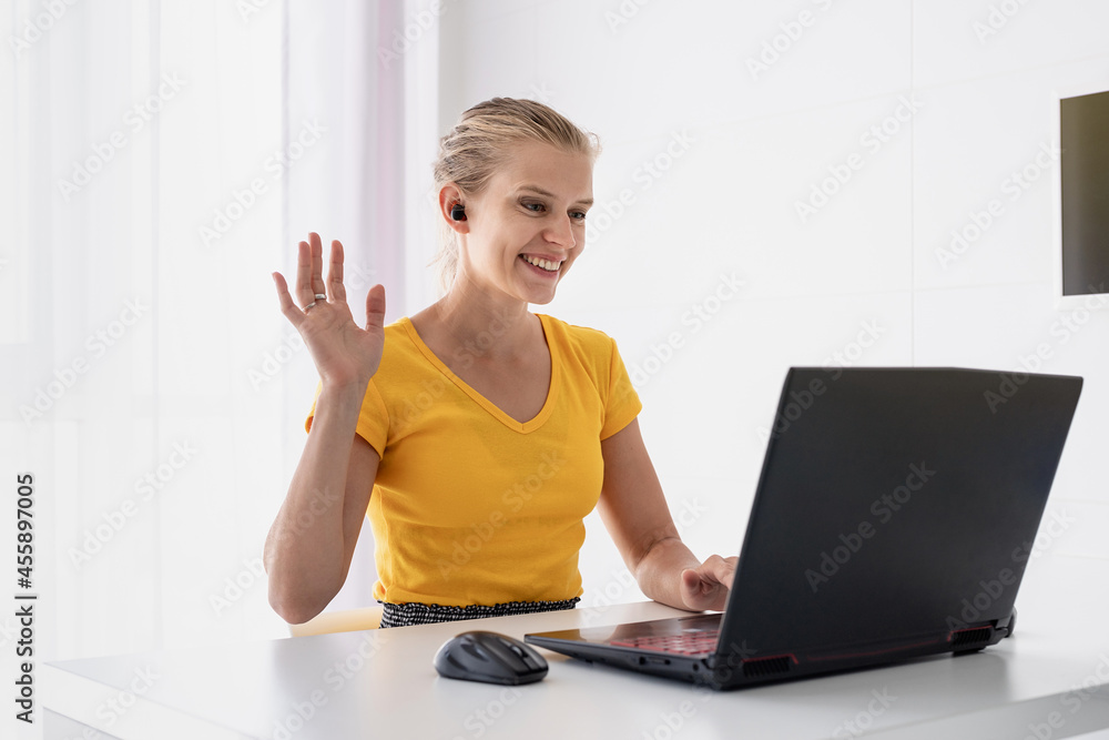 Young smiling woman working with laptop from home Young smiling woman working with laptop from home