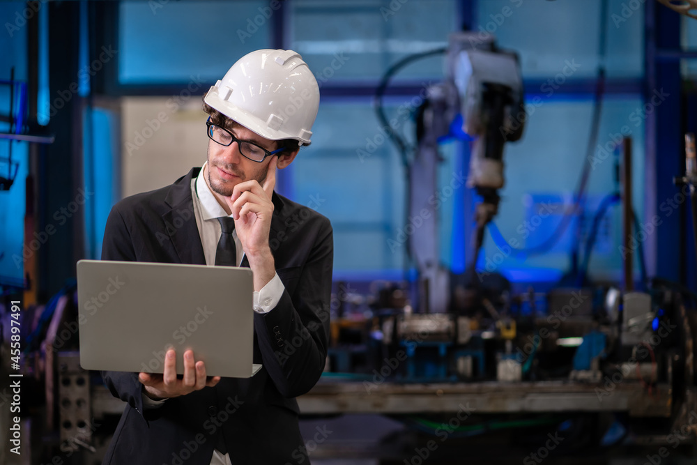 Engineer check and control automation robot arms.Robot arms machine in intelligent factory industrial on monitoring system software. Welding robotics and digital manufacturing operation. Engineer check and control automation robot arms.Robot arms machine in intelligent factory industrial on monitoring system software. Welding robotics and digital manufacturing operation.