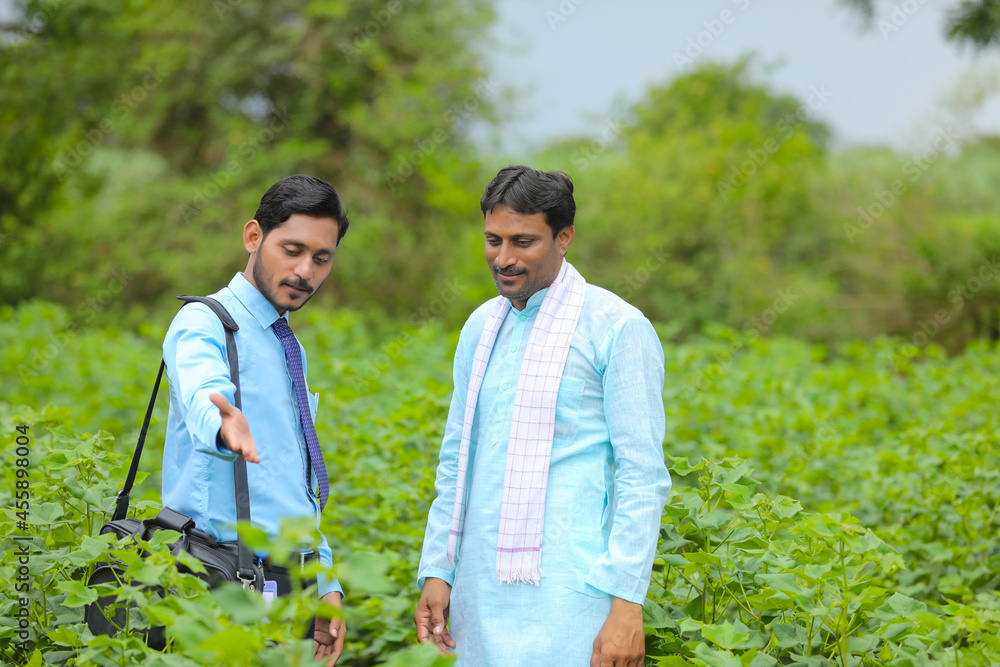 Indian farmer Discussing with agronomist at Farm and collecting some information Indian farmer Discussing with agronomist at Farm and collecting some information