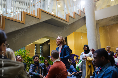 Speaker with microphone talking to audience